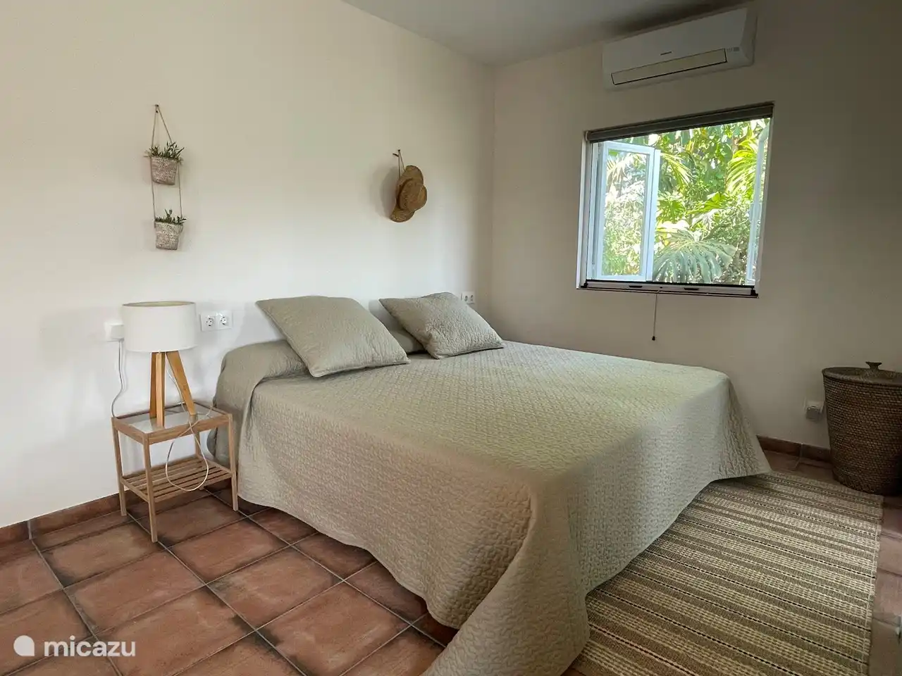 Double bed with a view of the tropical garden