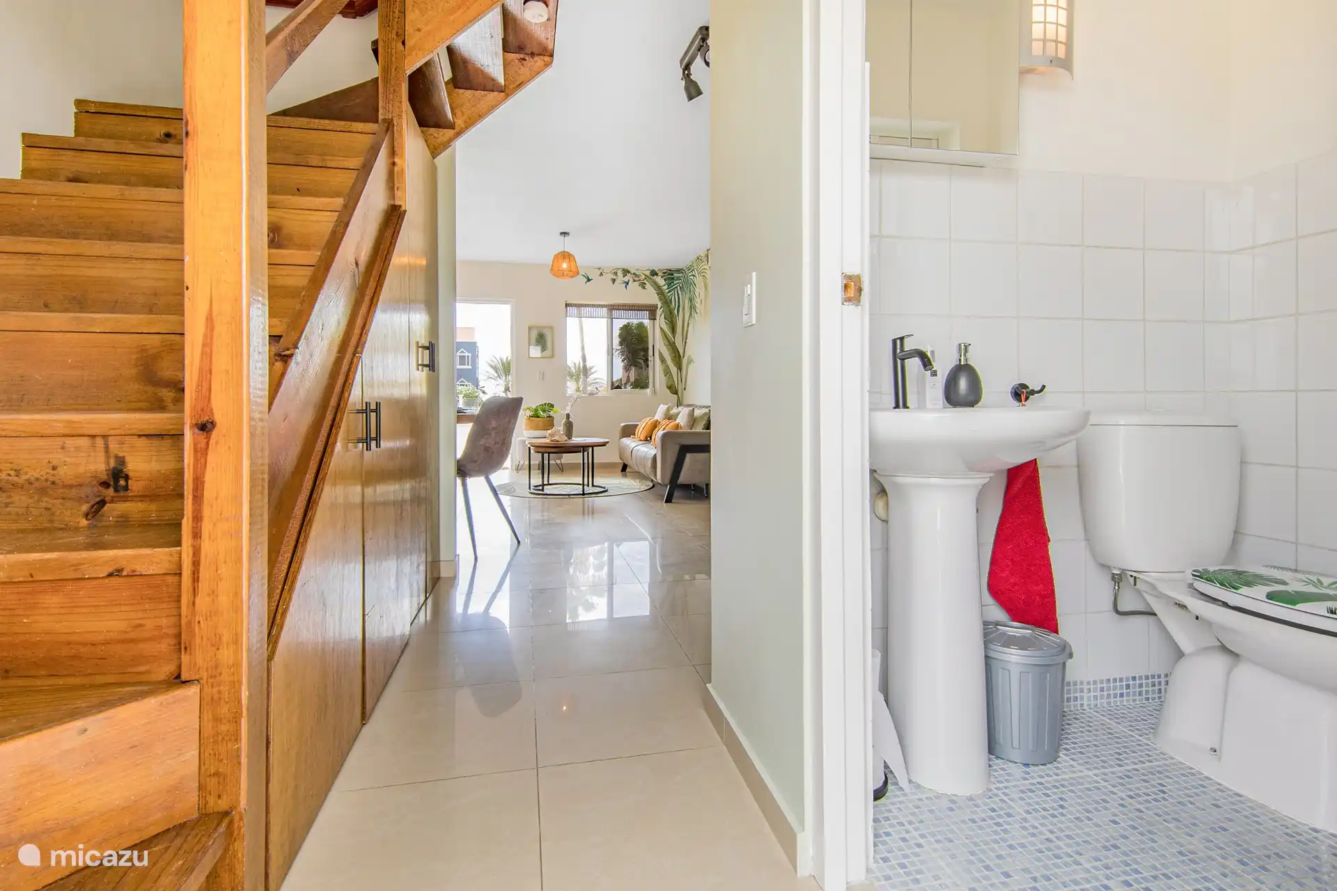 Beautiful wooden staircase to the upper floor with bedroom, loft, balcony and bathroom. In the picture you can see the extra toilet from downstairs