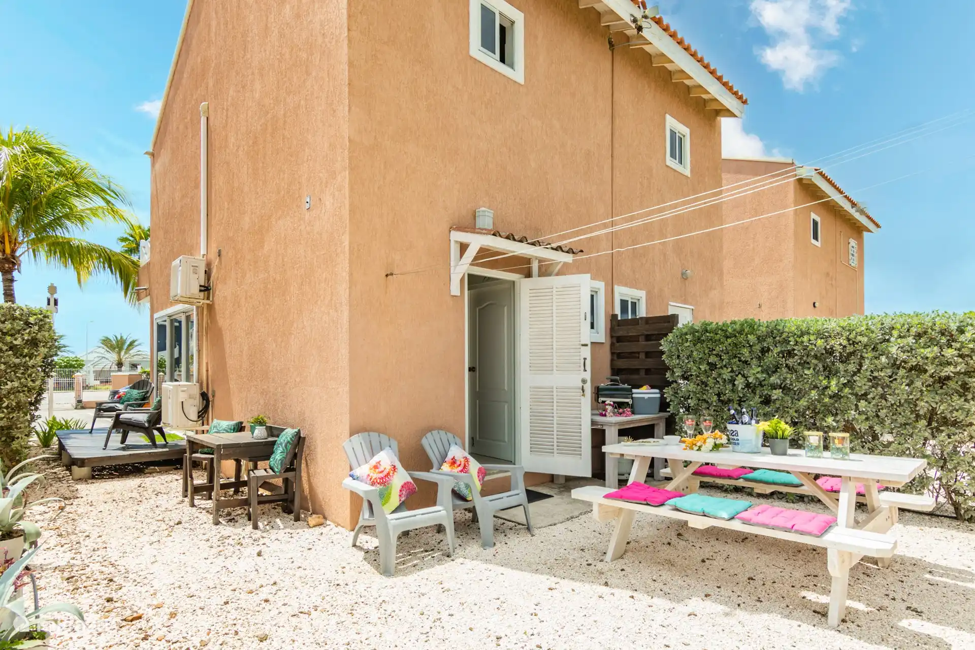 Back of the house with picnic bench where you can also sit on the wind