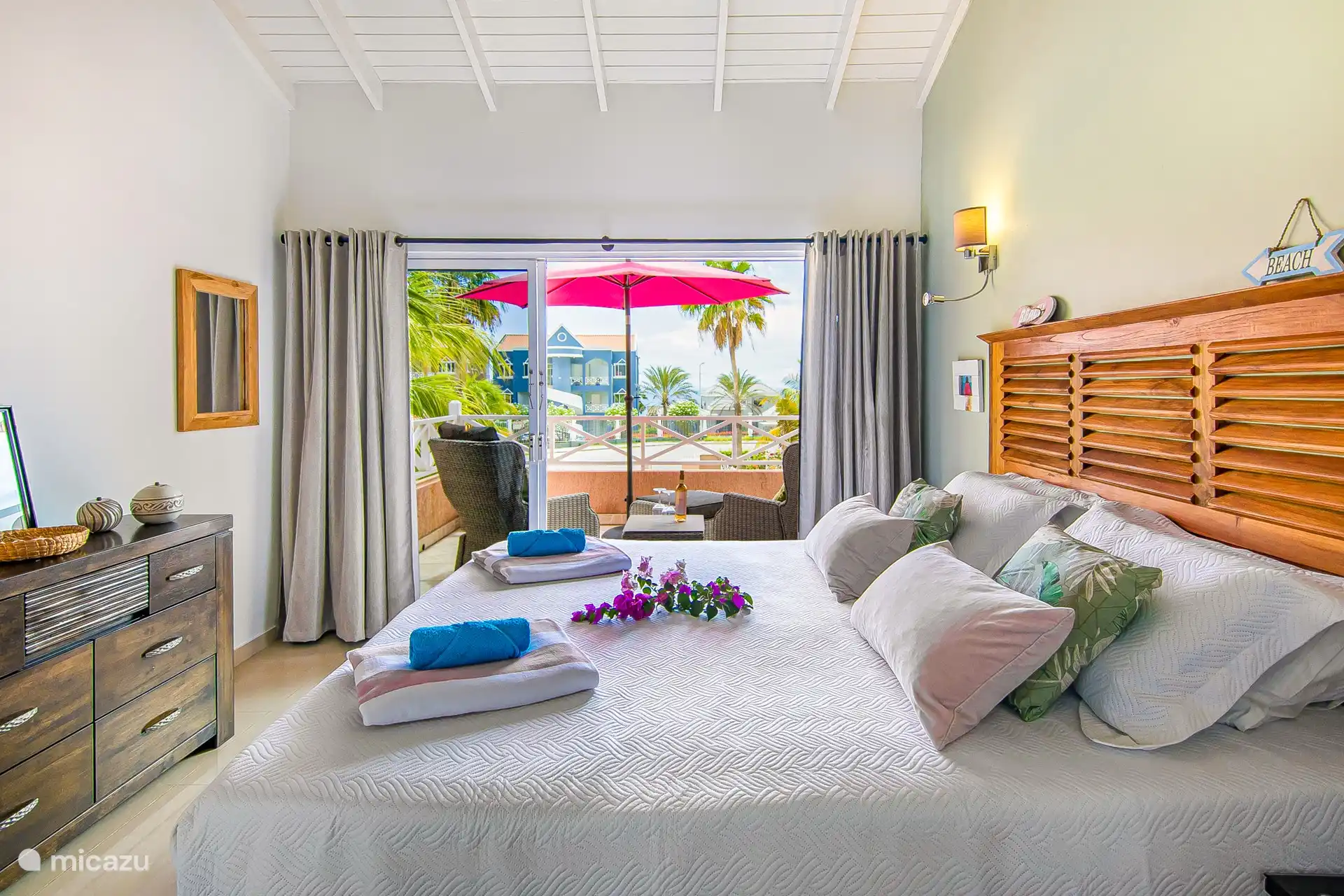 Bedroom with balcony next to the bedroom with lovely lounge chairs where you can enjoy a drink and maybe see a cruise boat pass by?