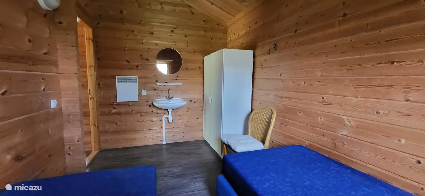 Schlafzimmer 1. Bestehend aus 2 separaten Boxspringbetten, einem Schrank und einem Waschbecken.