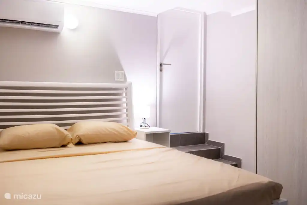 Bedroom 1 with the door to the bathroom