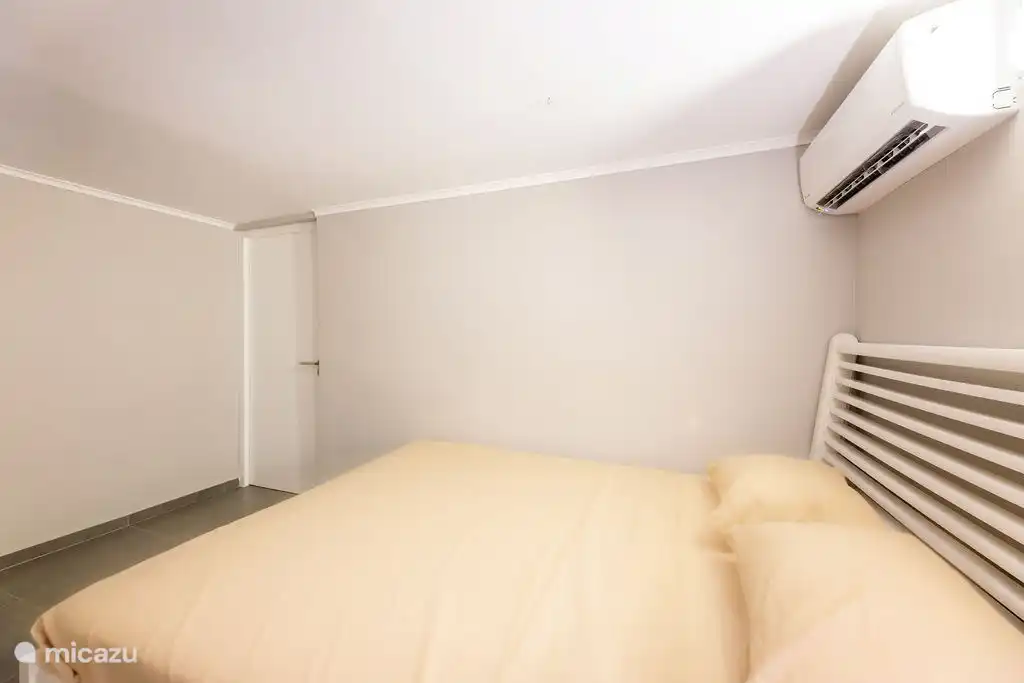 Bedroom 1 with the door to Bedroom 2