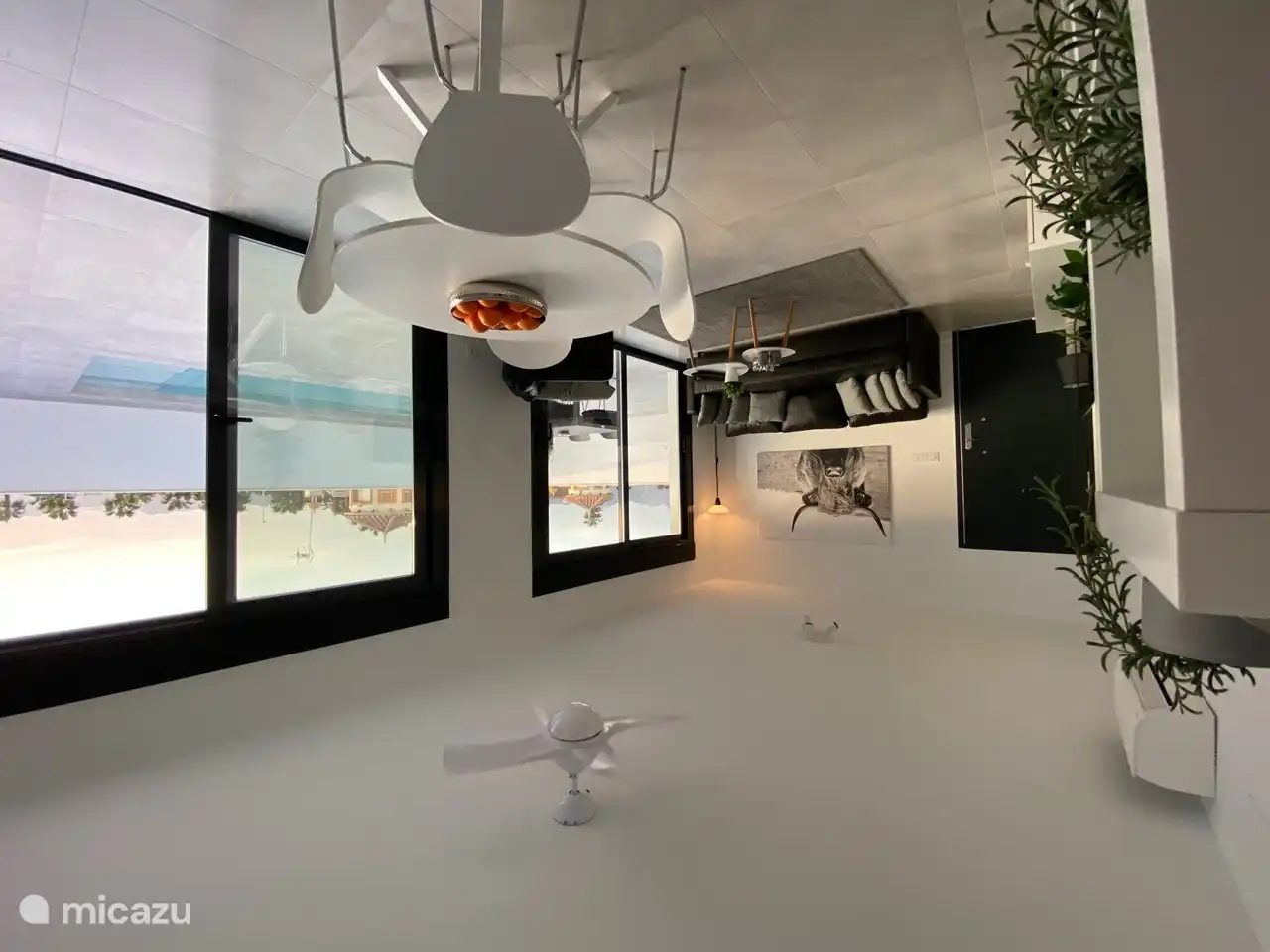Sala de estar con cocina abierta con mesa de comedor
