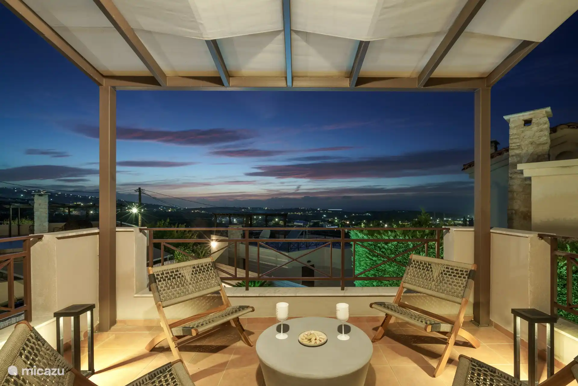 upper balcony lounge area with sunset and sea view