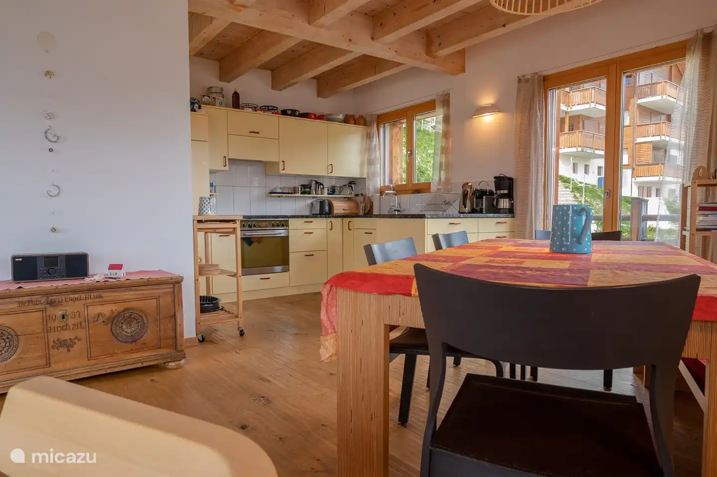 Living area with open kitchen and panorama window.