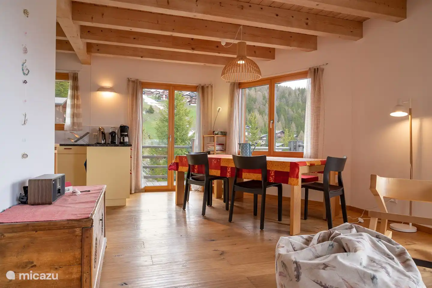 Living area with open kitchen and panorama window.
