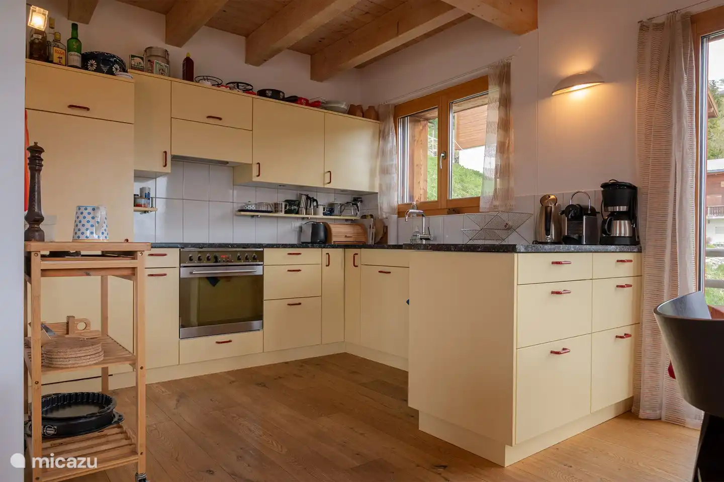 open kitchen with oven, dishwasher, toaster, kettle, cheese fondue