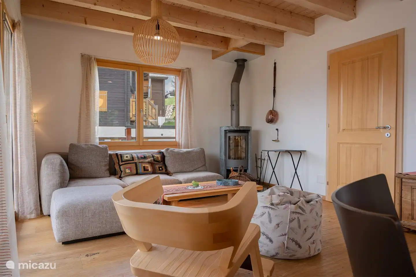 Living area with open kitchen and panorama window.