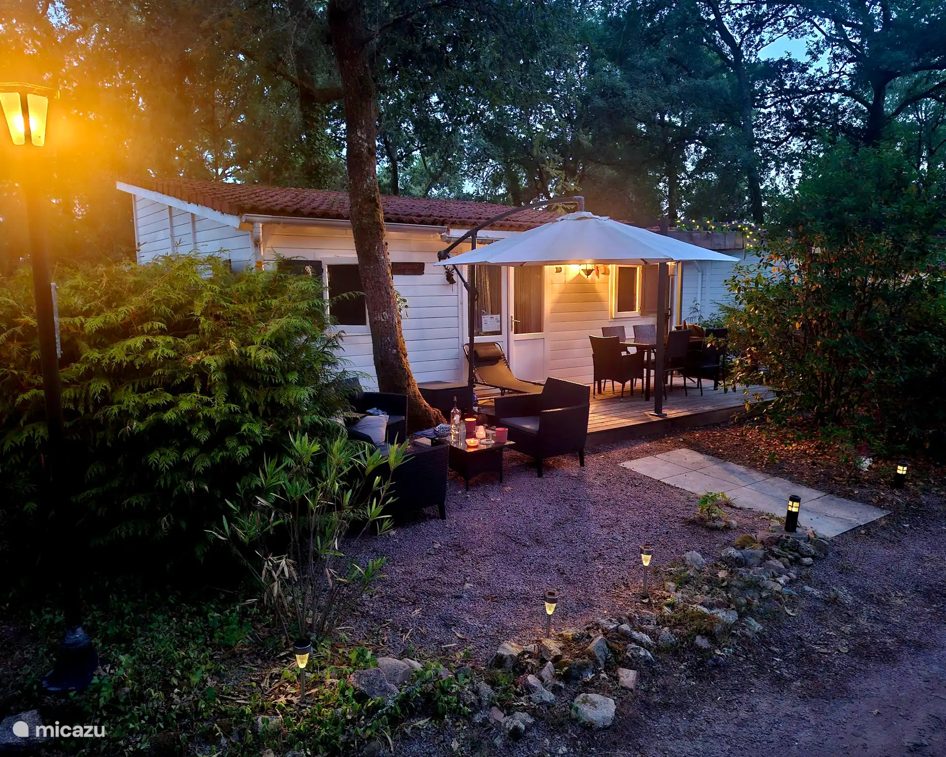 Chalet bij valavond met avondverlichting.