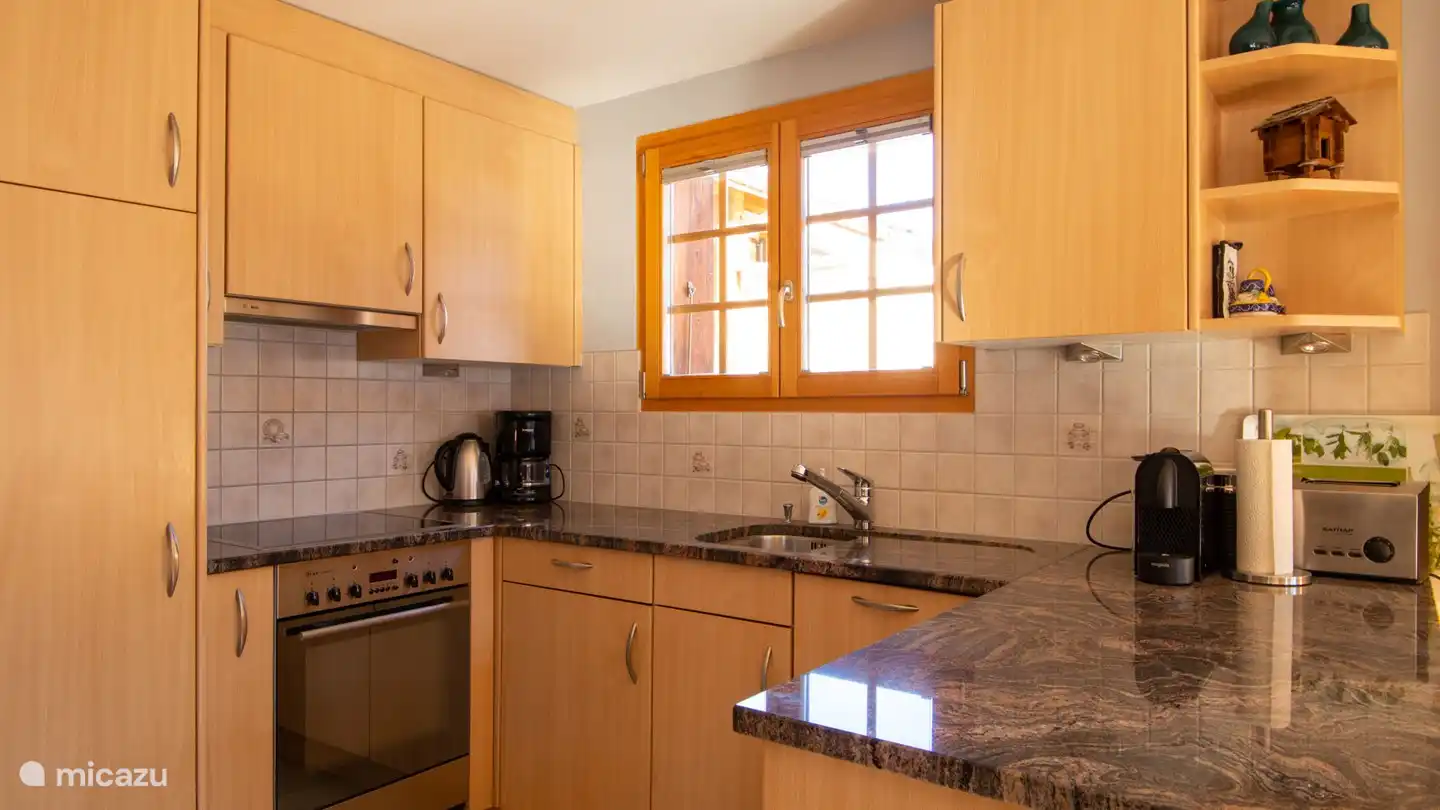 open kitchen with oven, dishwasher, microwave, toaster, kettle, cheese fondue