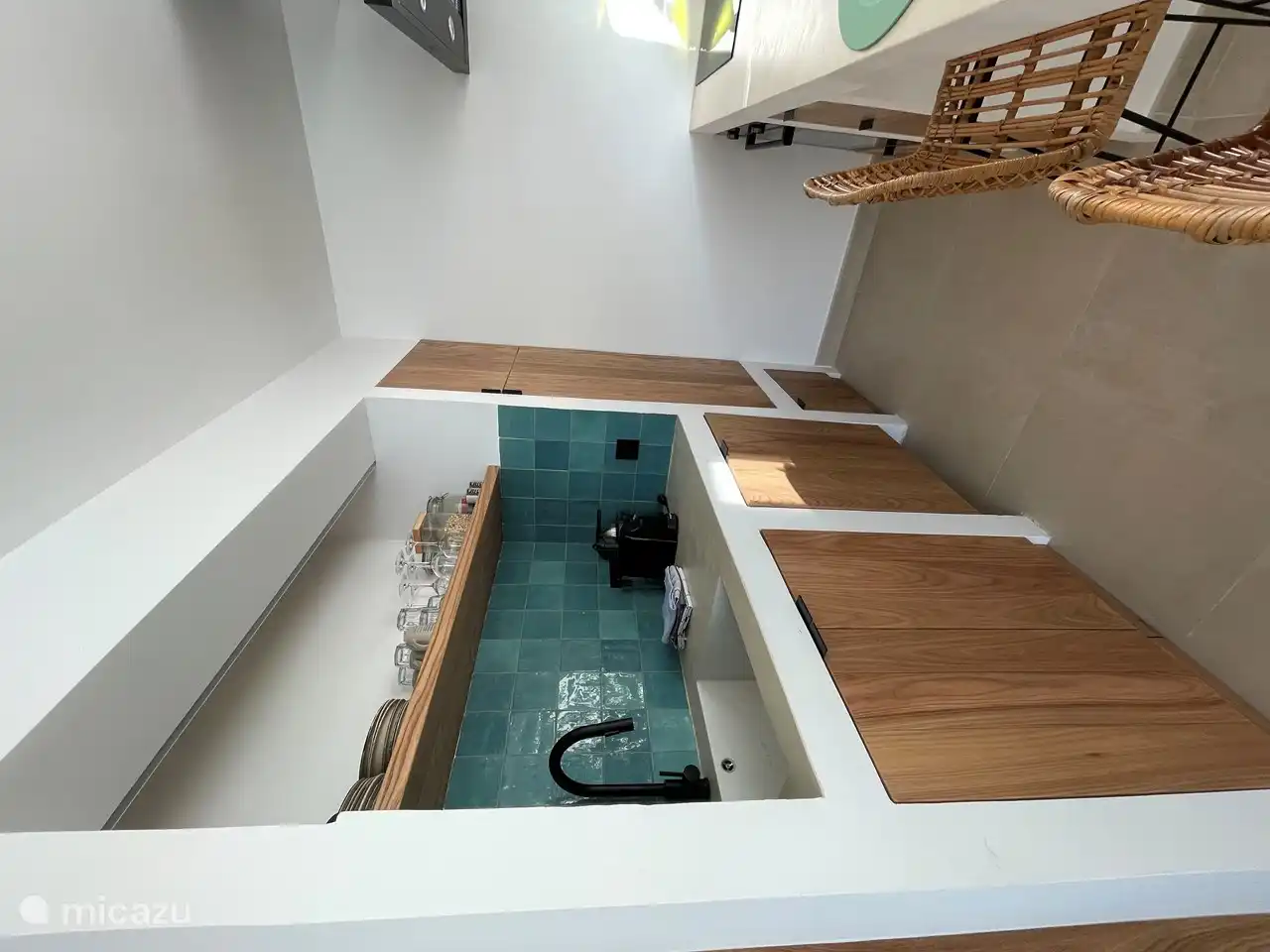 Open kitchen in Ibiza style with induction hob, oven, fridge with freezer compartment, dishwasher, Nespresso machine and juicer.