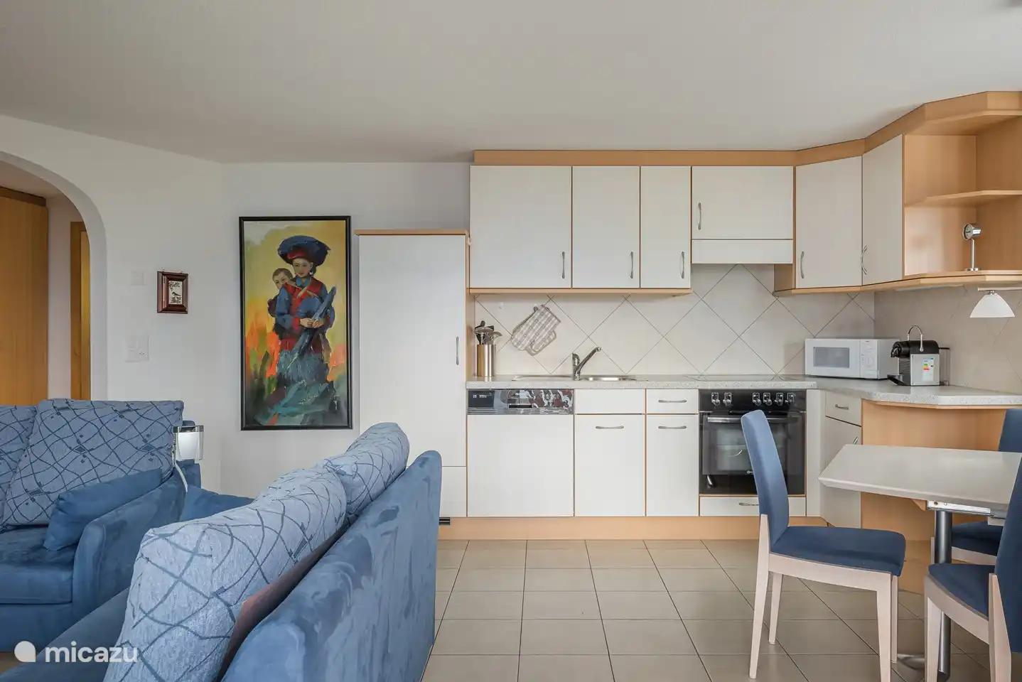 Living and dining area with panoramic windows and south-facing balcony with a clear view of the mountains opposite and the Valais Alps.