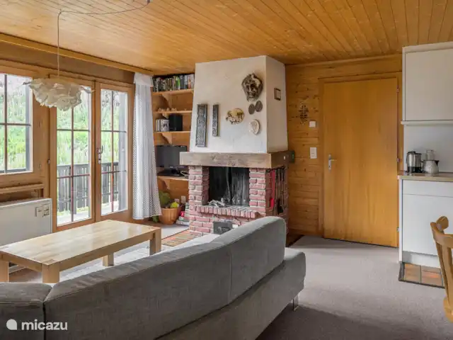 Location de Vacances Suisse, Valais, Bettmeralp, appartement - Jadwiga OG Un salon et une salle à manger ouverts vous invitent à vous attarder. Les soirées plus fraîches peuvent être passées sur le canapé spacieux près de la cheminée.