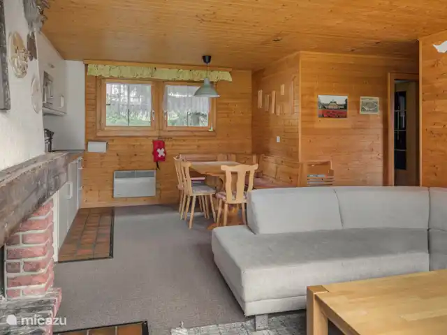 Location de Vacances Suisse, Valais, Bettmeralp, appartement - Jadwiga OG Un salon et une salle à manger ouverts vous invitent à vous attarder. Les soirées plus fraîches peuvent être passées sur le canapé spacieux près de la cheminée.