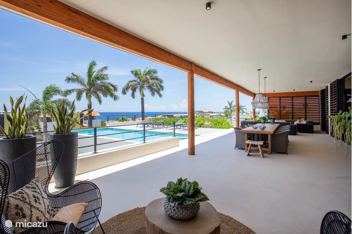 The covered porch has several seating areas.