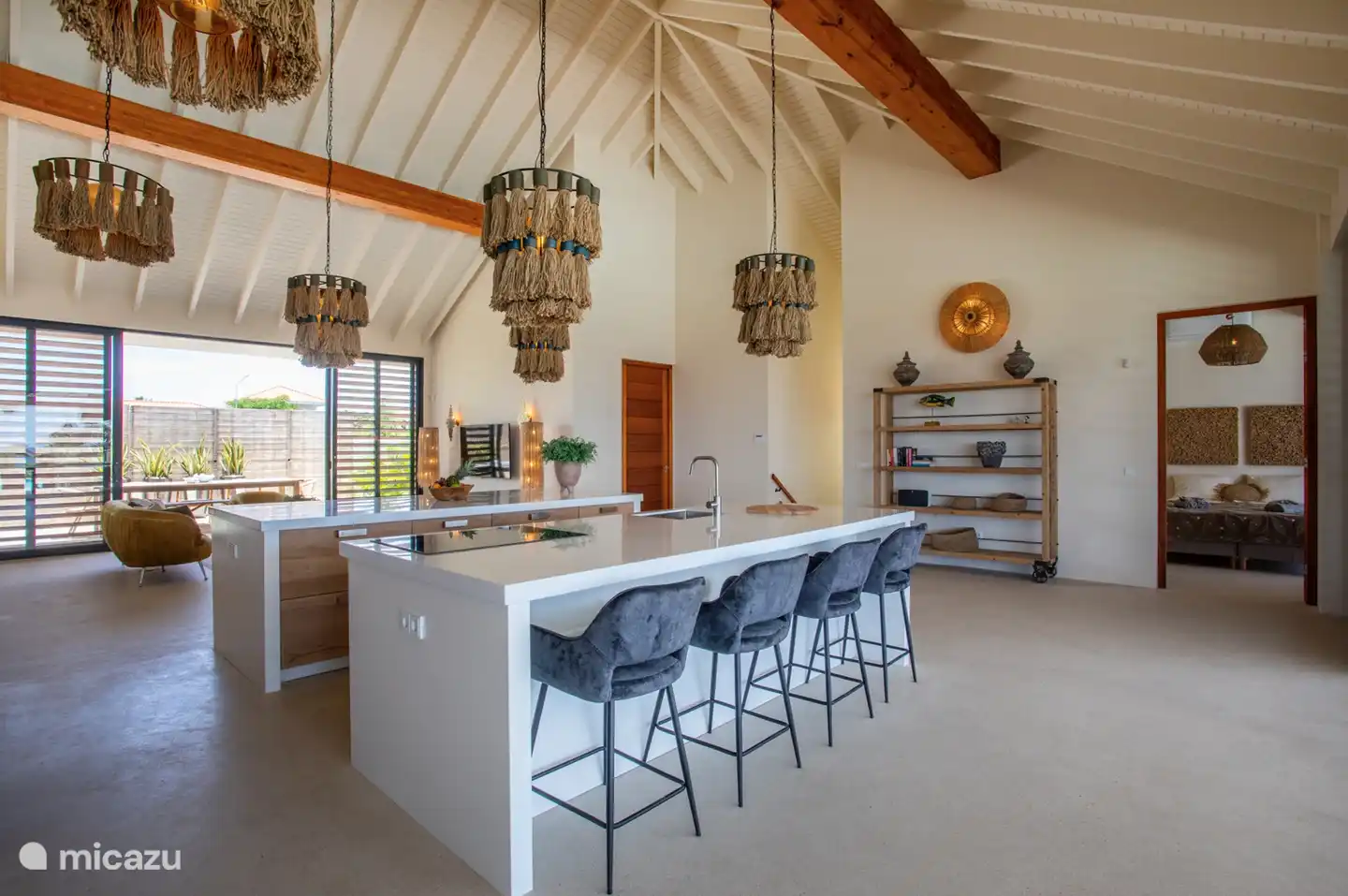 The stylishly equipped kitchen is located in the middle of the living room