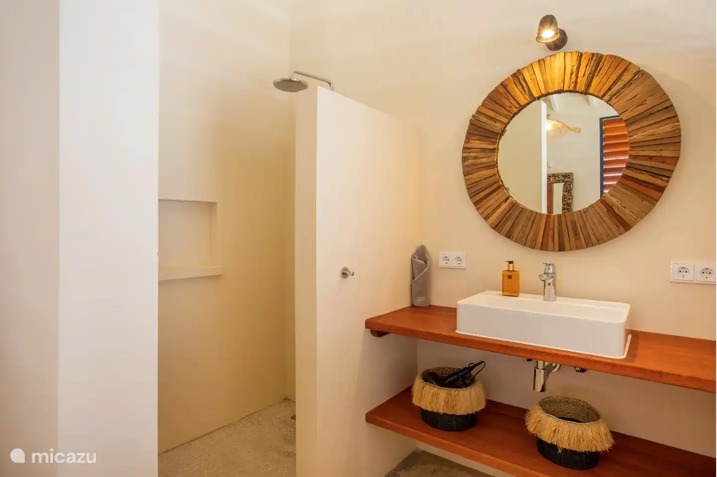 Bathrooms have a rain shower, sink and toilet.