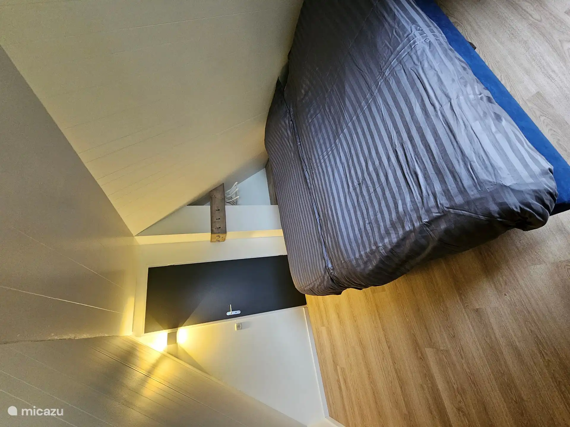 3rd bedroom with balcony and view over the fish pond.