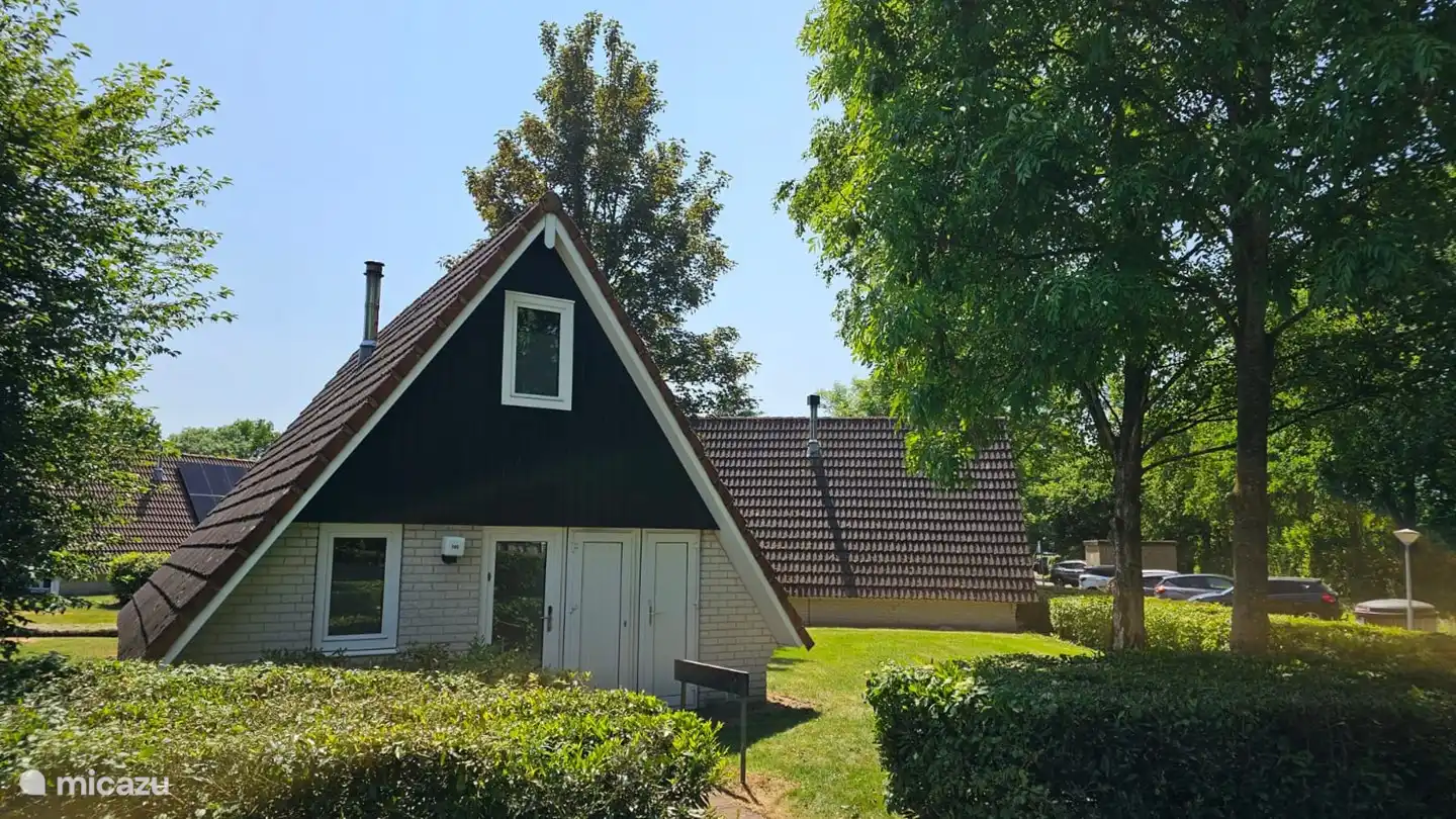 Front of the 6-person holiday home Time4vacay house 145, with the parking lot on the side