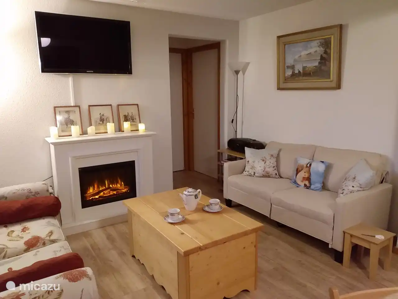 The living room is cozy and equipped with an electric fireplace
