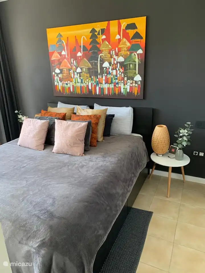 El dormitorio principal tiene dos armarios y se encuentra junto a un baño con ducha, lavabo y dos mesitas de noche. Disfrute de la vista del patio con piscina.