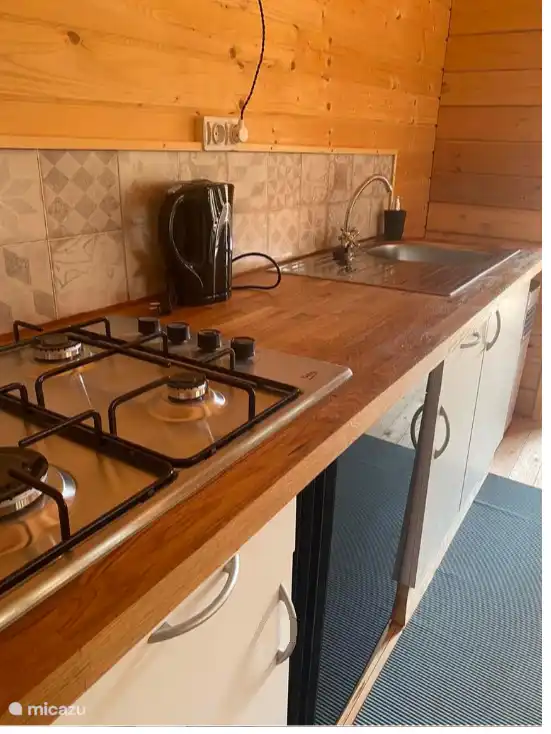 De keuken met gasfornuis en koelkast 