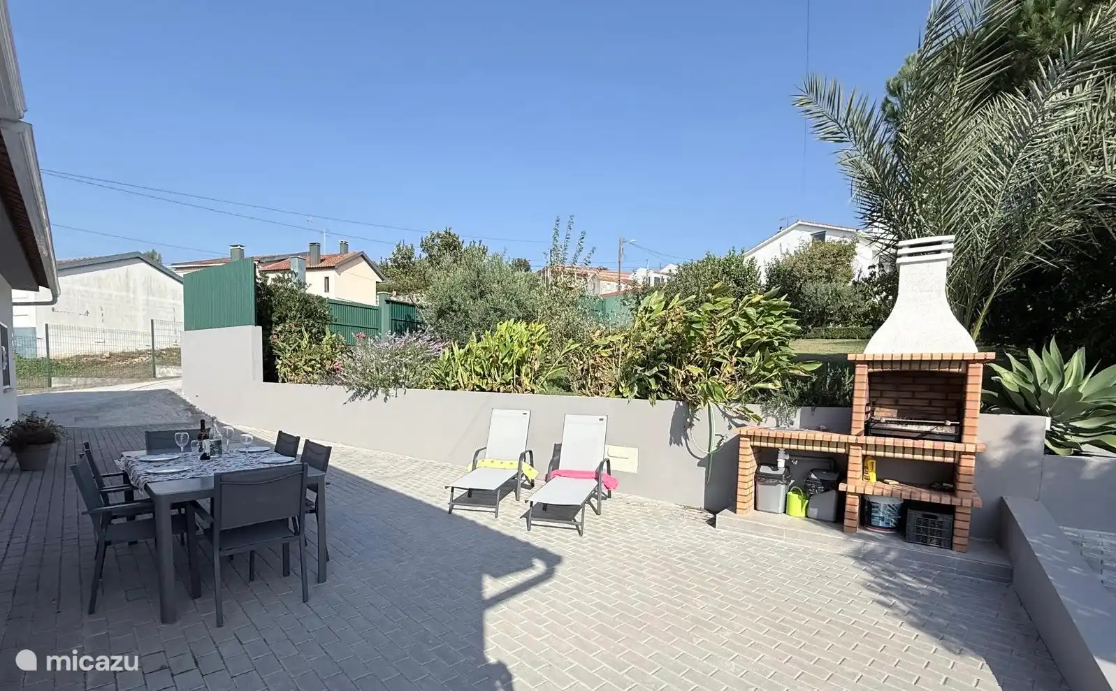Terrace with sun loungers. Table with 6 chairs and typical Portuguese barbecue with sink and sink