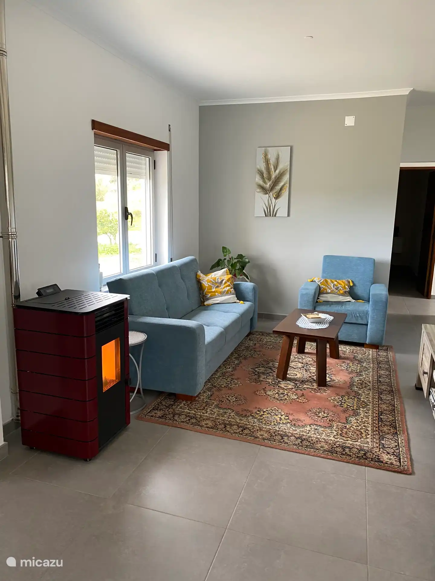 3 seater sofa with TV cabinet and pallet stove for the chilly winter evenings