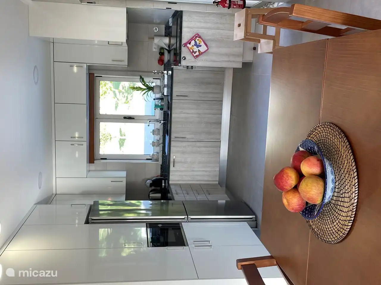 Spacious kitchen with built-in appliances and a view of the beautiful garden.