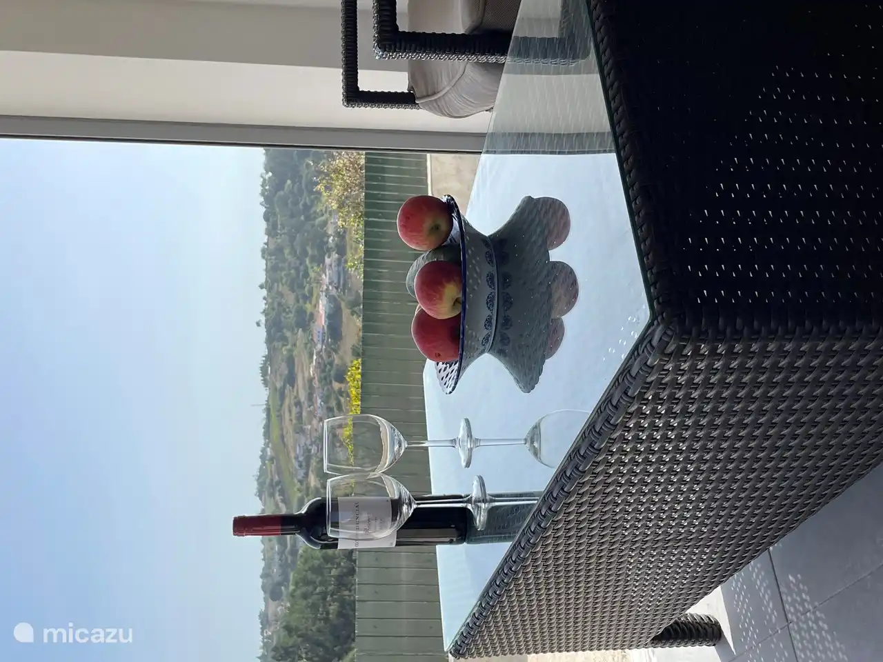 View from covered terrace which can be partially closed by means of a roller shutter.