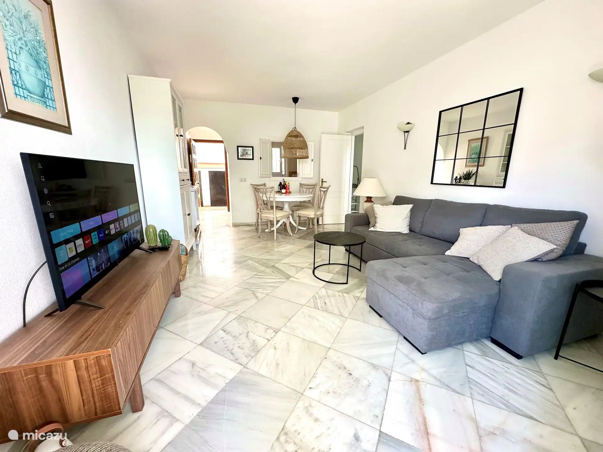 The living room has a sofa bed and is also equipped with air conditioning.