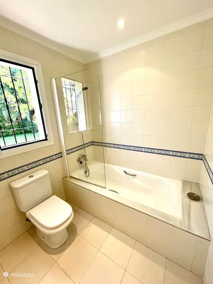 The house has a large bathroom with sink, bath and toilet and a second bathroom with sink, shower and toilet.