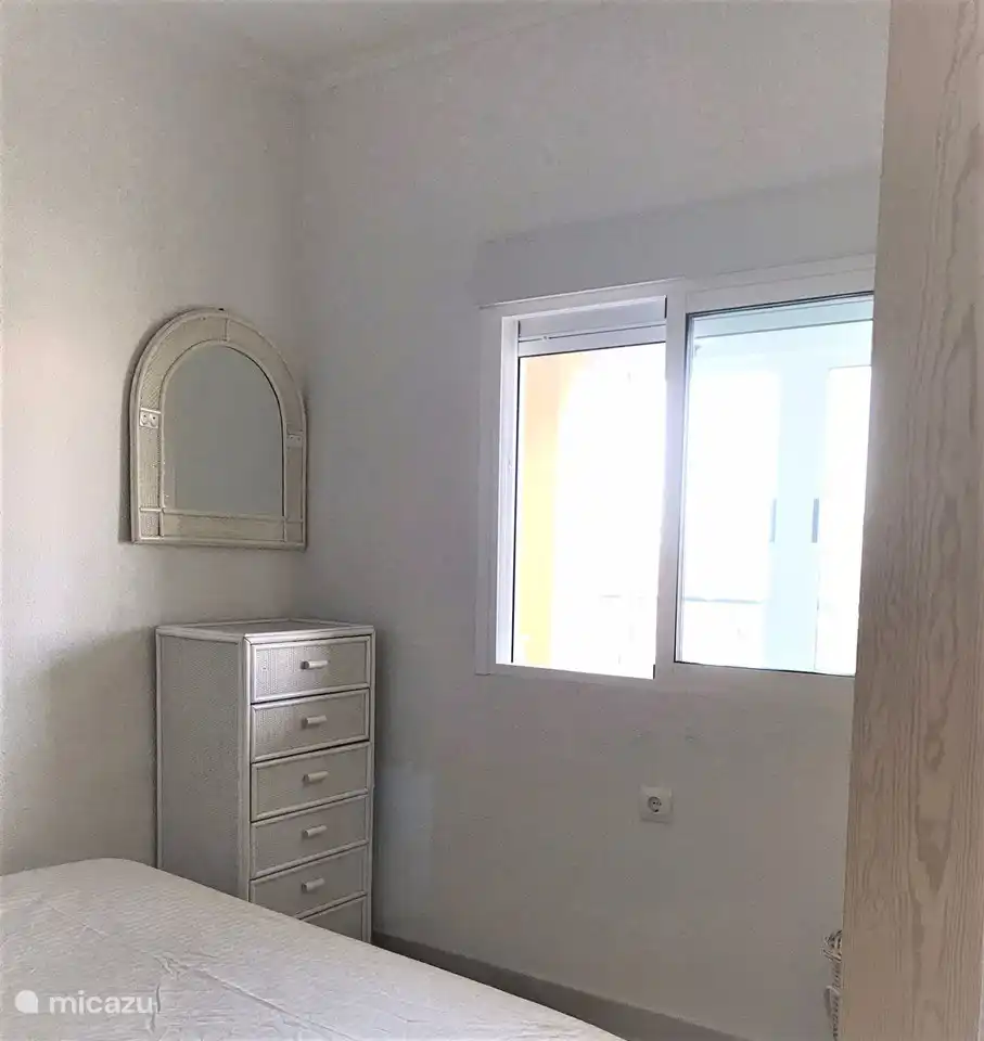 chest of drawers and mirror in the second bedroom