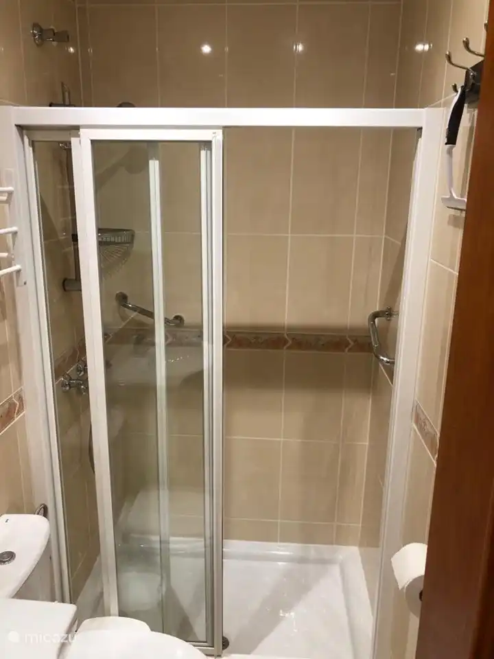 walk-in shower and plenty of hooks on the wall for your clothes