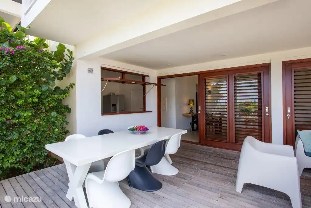 Coin repas extérieur et trappe vers la cuisine.