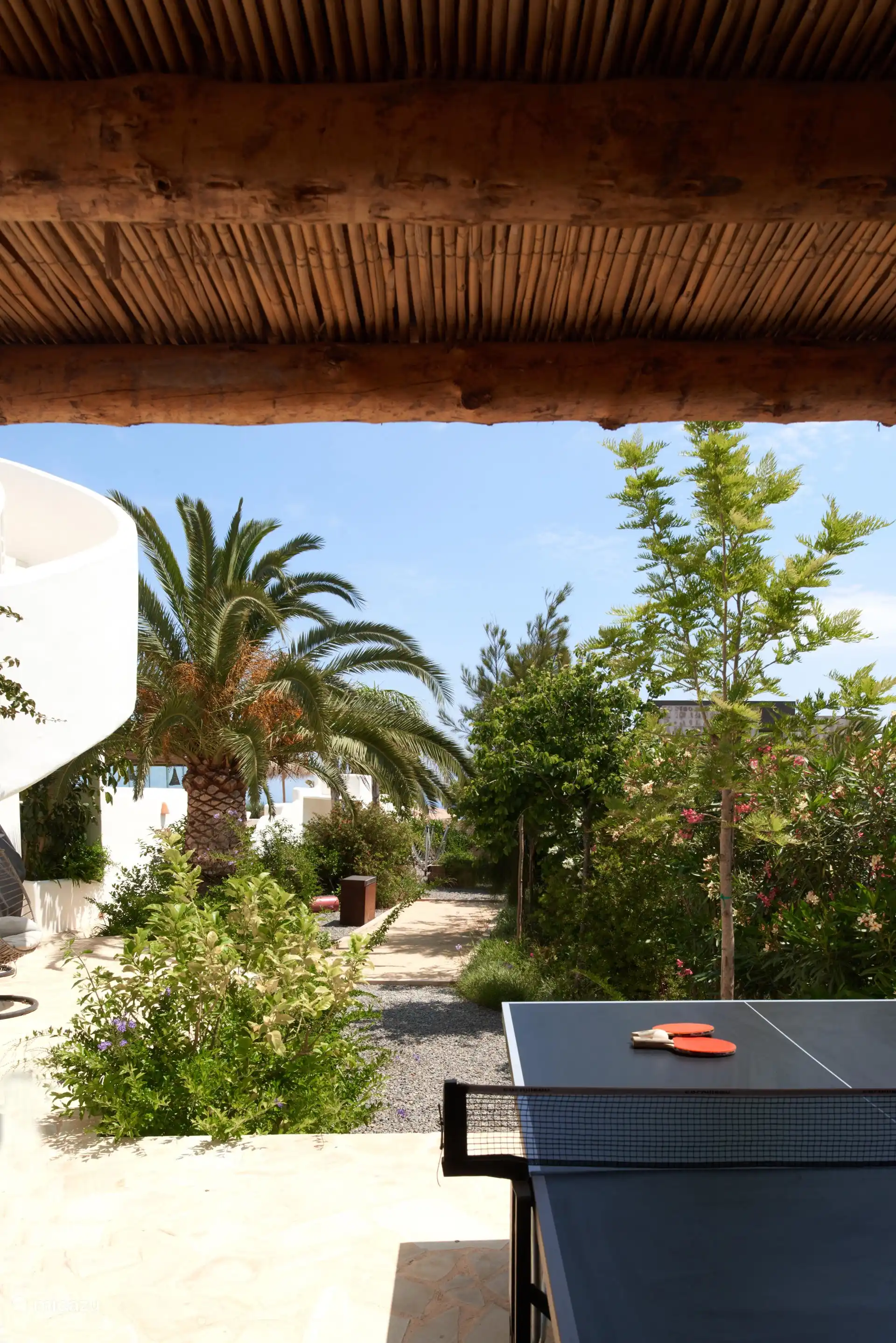 There is a table tennis table in the garden. 