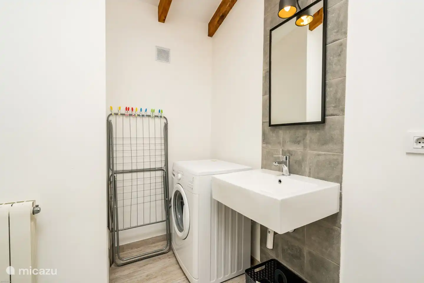 Badezimmer mit Waschmaschine, Toilette und Waschbecken