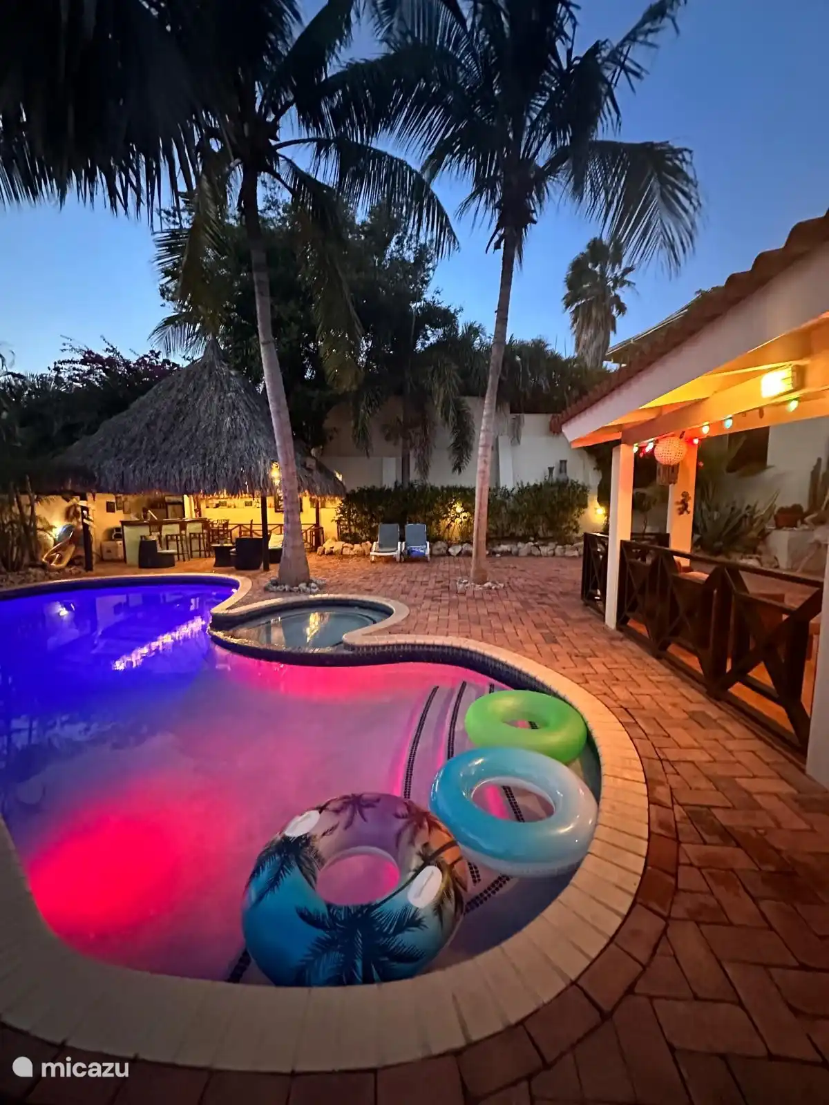 Pool, Palappa und Bar am Abend