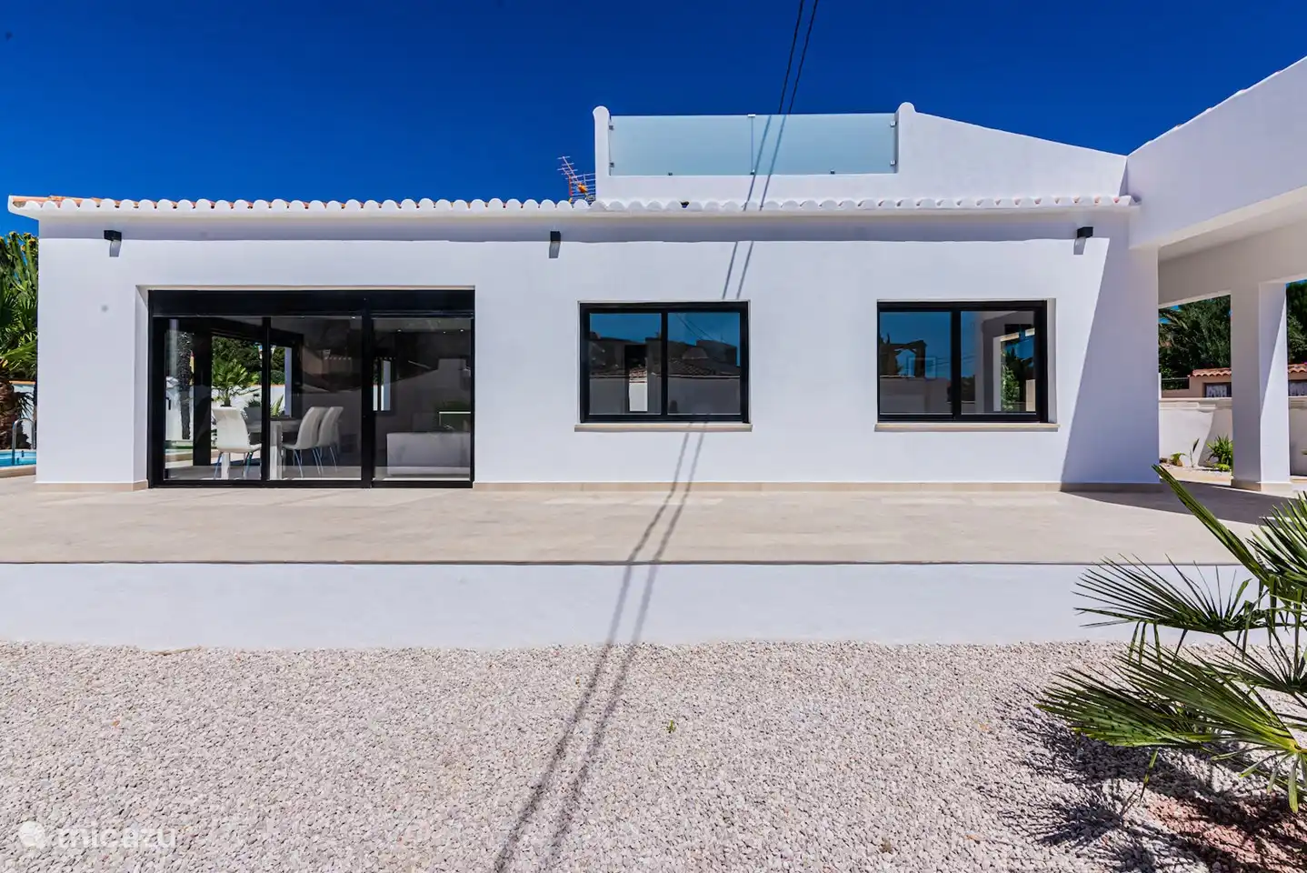 side of the house where the terrace is located. The roof terrace is located on top of the villa.