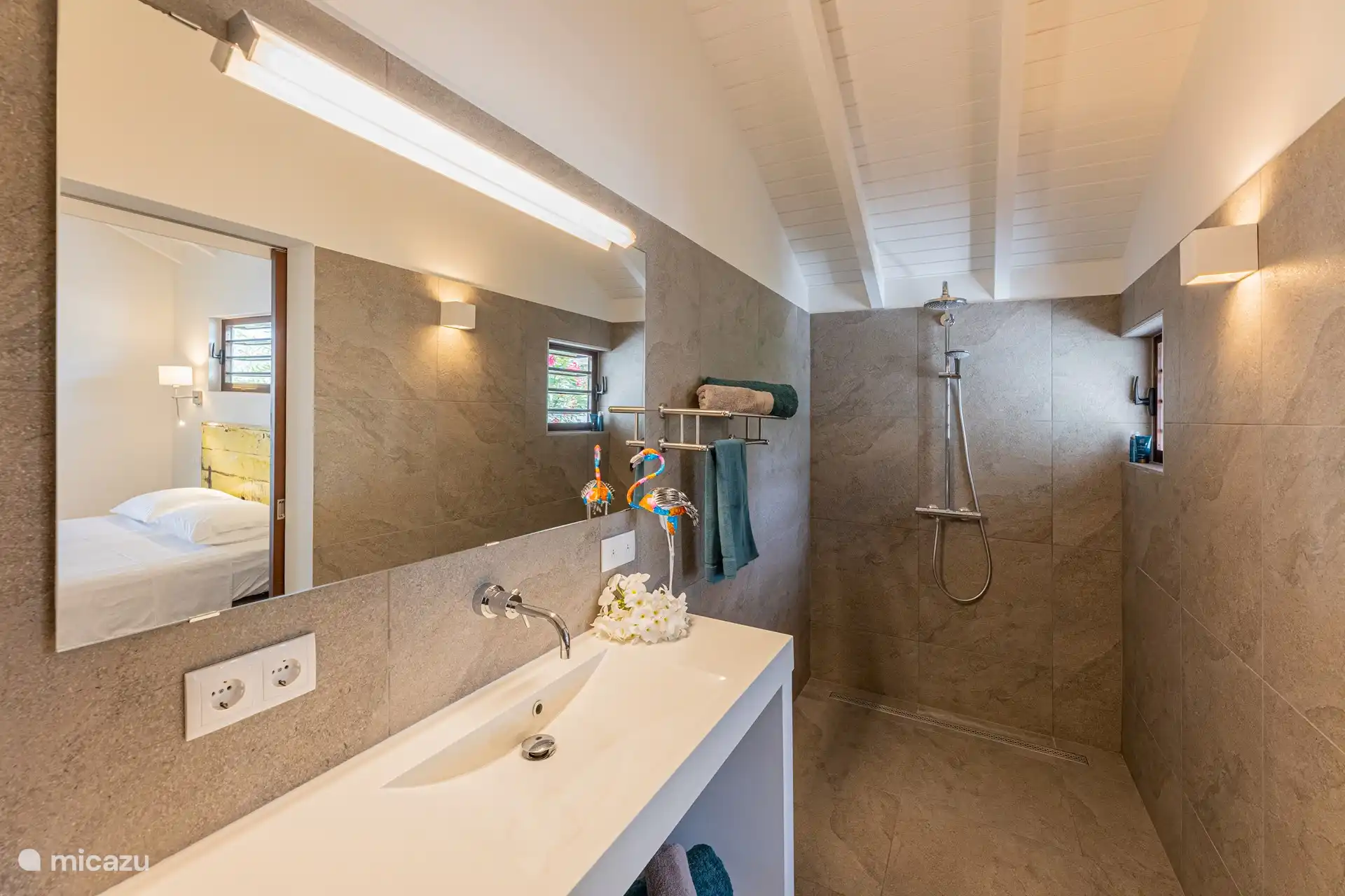 The bathroom with spacious walk-in shower