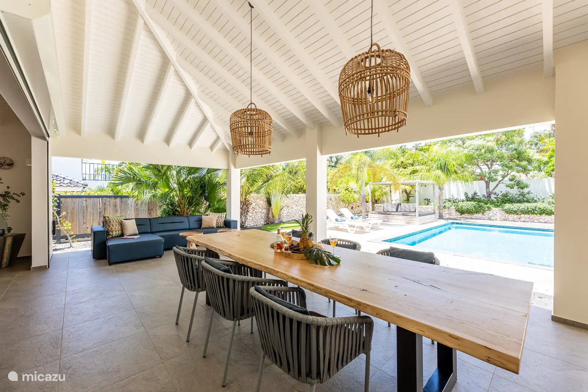 The terrace has a dining table and lounge sofa.