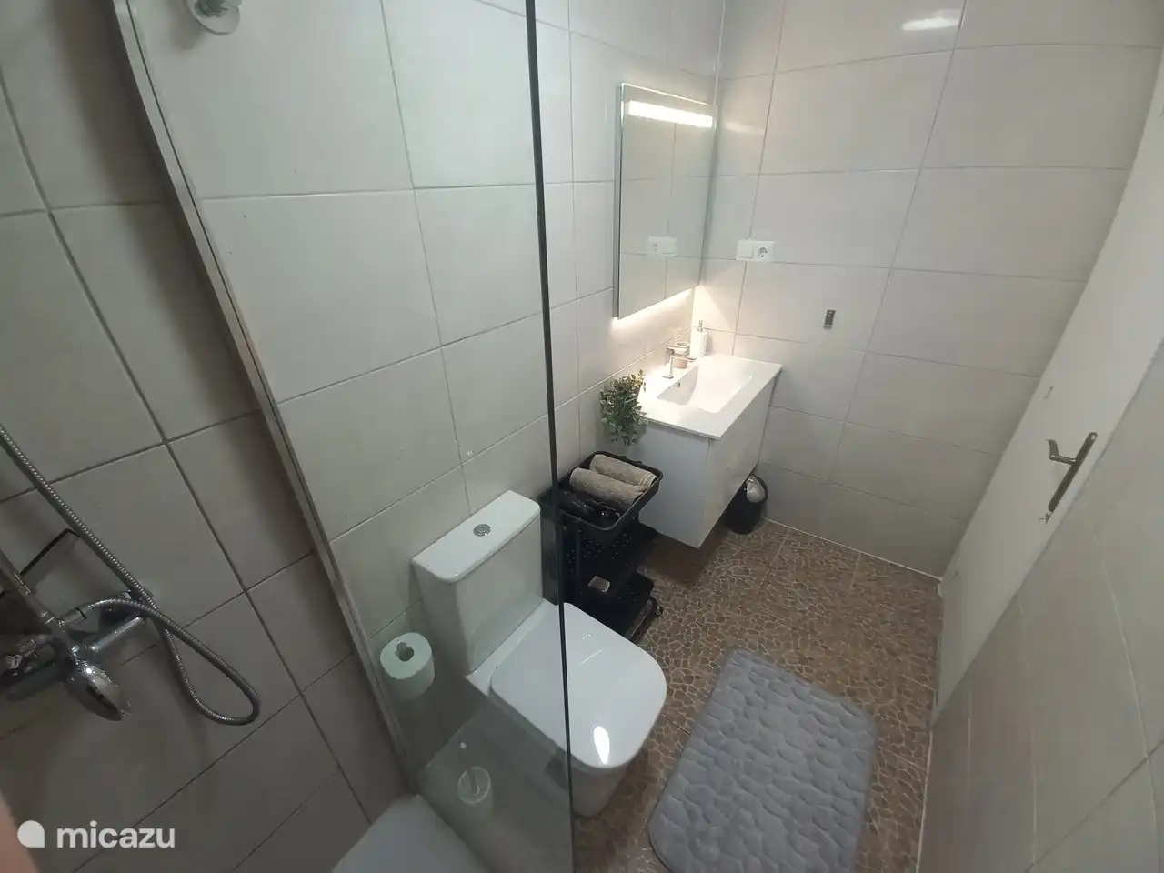 New bathroom with rain shower. Without step with non-slip floor.