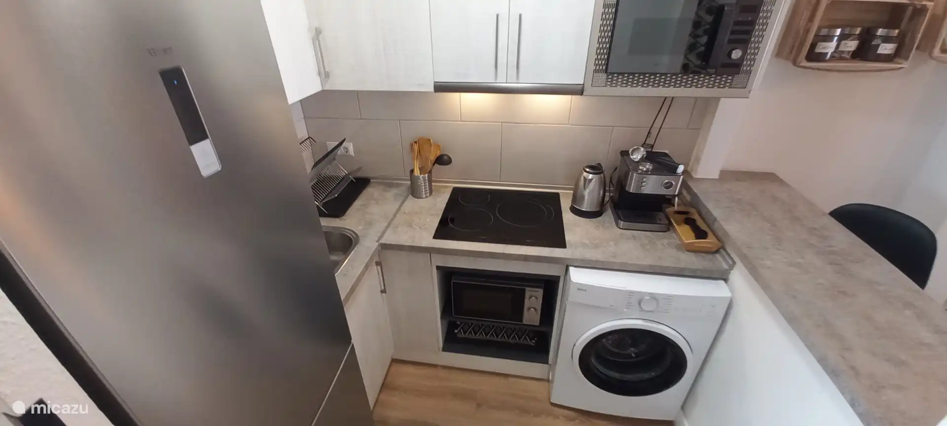 There is also a washing machine in the kitchen.