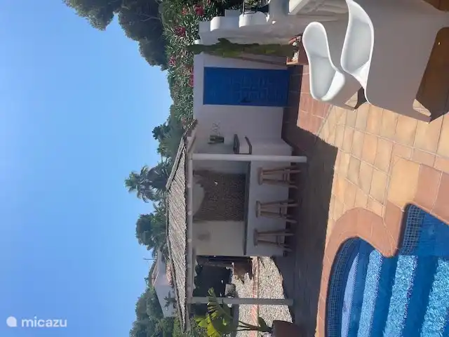 Bar extérieur douillet au bord de la piscine 