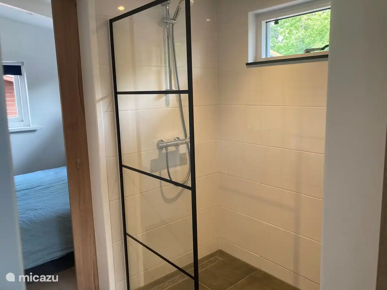 The bathroom with walk-in shower