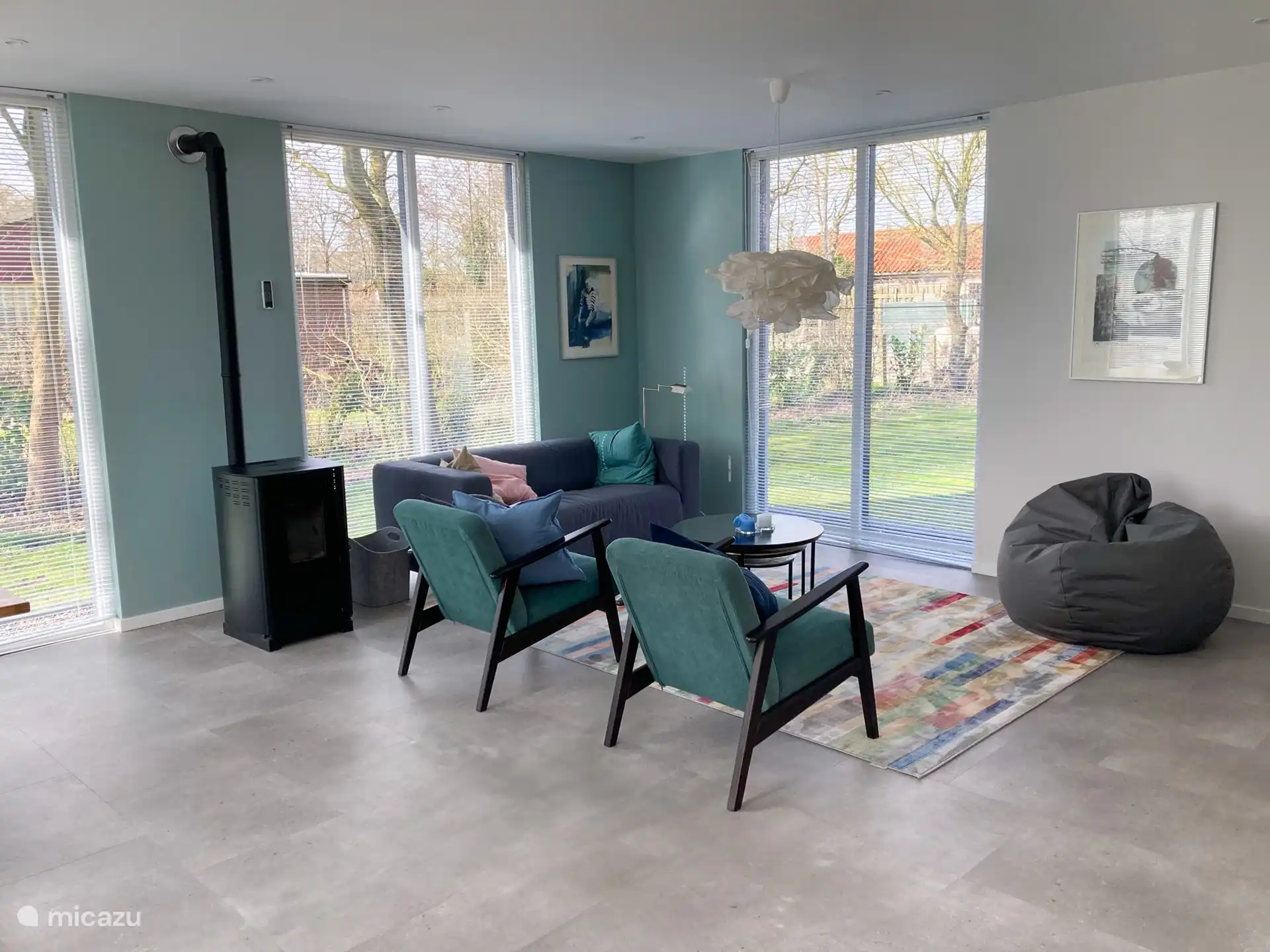 The seating area with a double sofa, two chairs and a bean bag