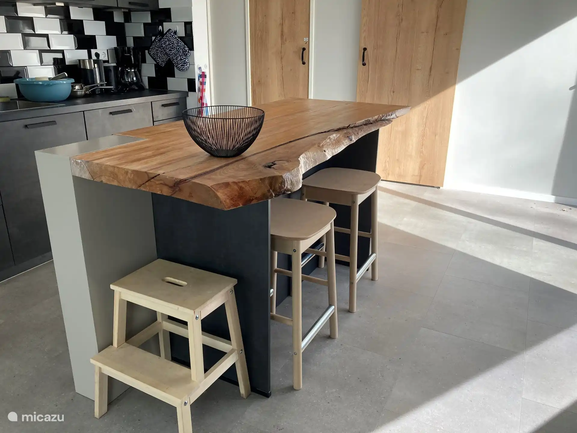 The kitchen unit with bar stools