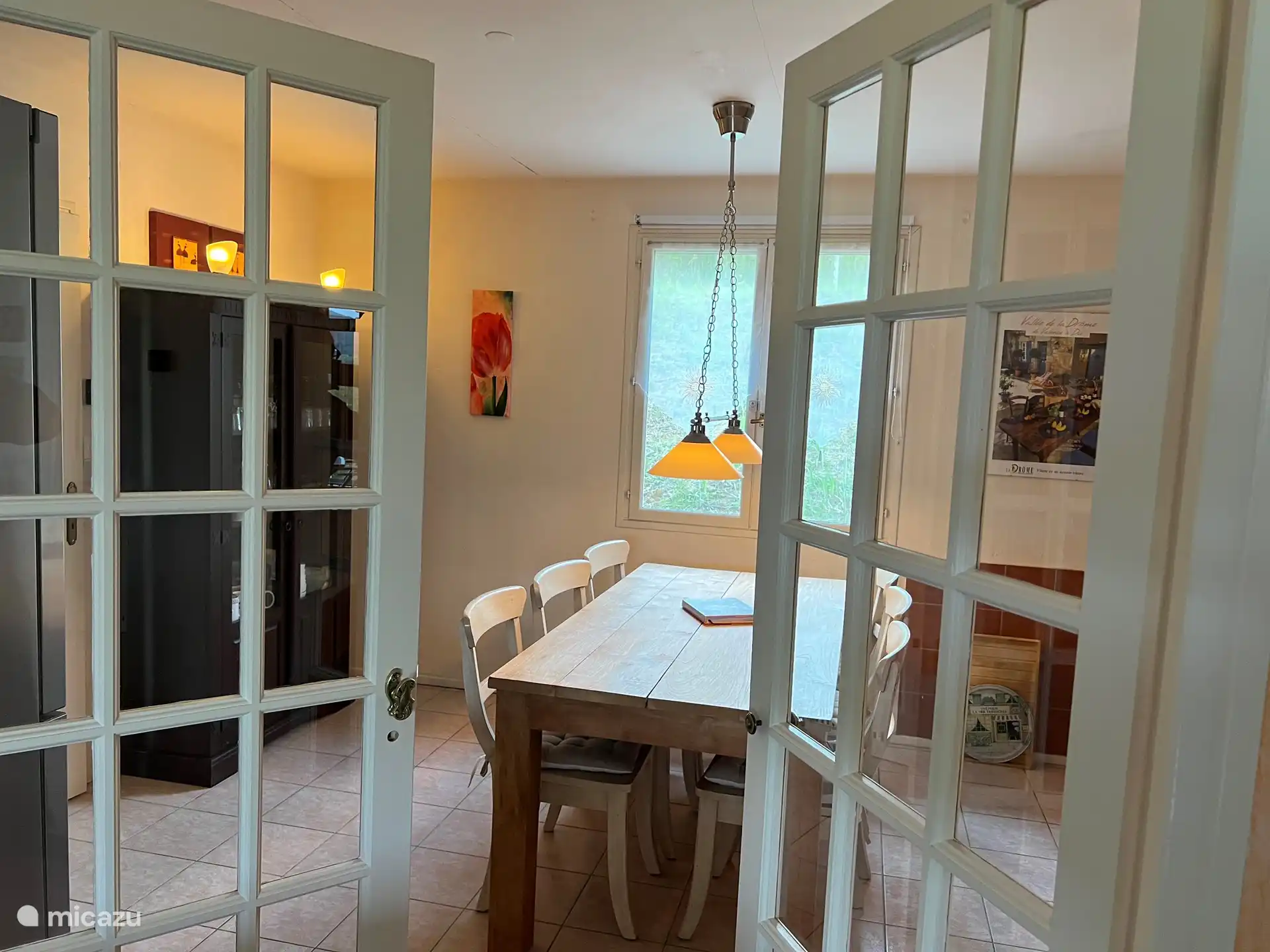 Glass doors separate the living room from the spacious kitchen/diner