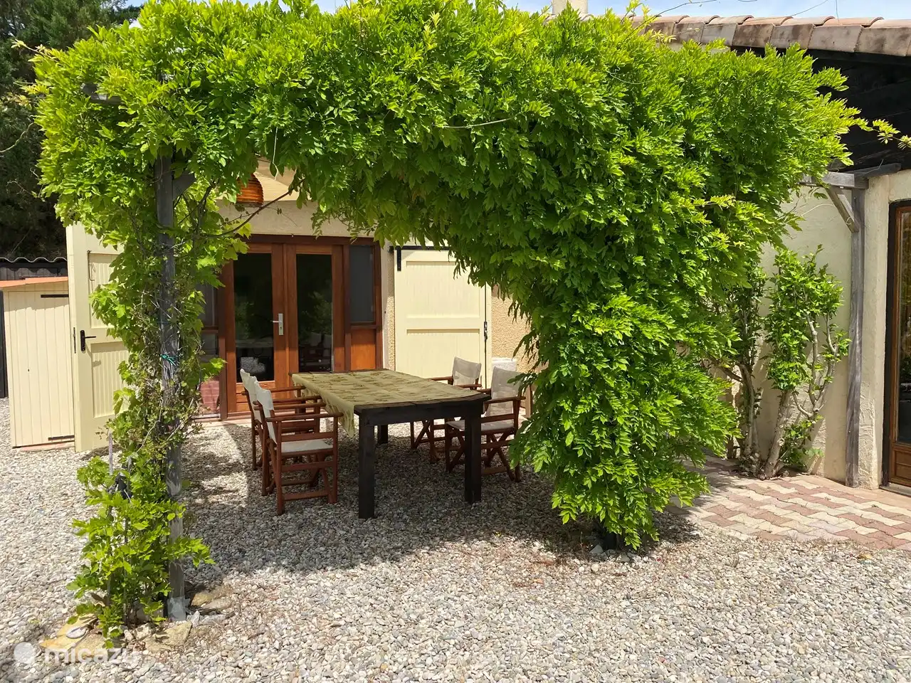Access to bedroom 2 from under the pergola with spacious dining table. (This bedroom can also be reached from the inside via the utility room).